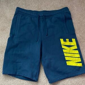 Nike Men's Dark Blue Athletic Shorts with Yellow Logo